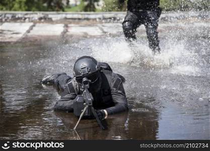 Spec ops police officers SWAT in action in the water. Spec ops police officers SWAT in the water