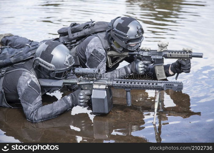 Spec ops police officers SWAT in action in the water. Spec ops police officers SWAT in the water