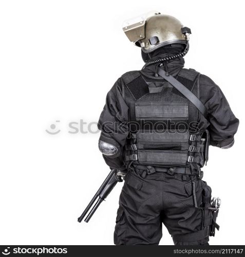 Spec ops soldier in black uniform and face mask shot from behind