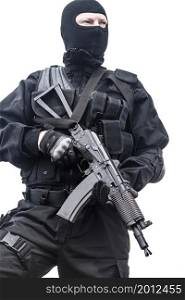 Spec ops soldier in black uniform and face mask with his rifle