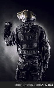 Spec ops soldier on black background shot from behind