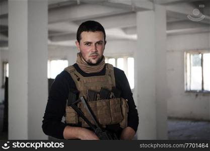 special agent  soldier portrait wearing  casual clothing with  protective army tactical gear  and weapon
