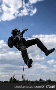 Special forces operator during assault rappeling with weapons. rappeling assault