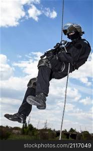 Special forces operator during assault rappeling with weapons. rappeling assault