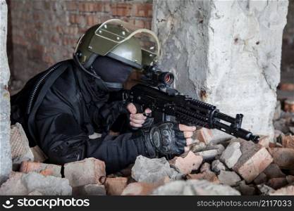 Special forces operator in black uniform and bulletproof . Special forces operator