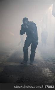 Special forces operator in black uniform in the smoke. assault in the smoke