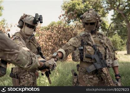 Special forces soldier in camouflage, fist bump and send energy to each other before performing an attack on.