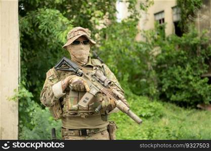 Special forces soldier in camouflage with a pair of weapons that are full of modern technology and complete for battle