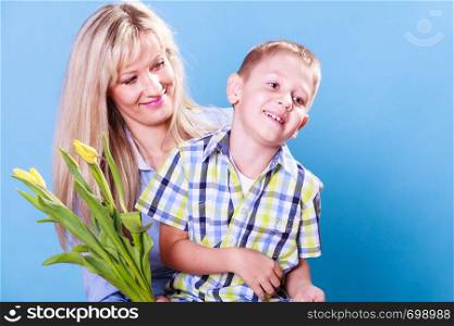 Special occasions holiday and mother day. Young boy spend time with mother celebrate together give flowers gift.. Mother and son celebrate mothers day.