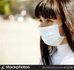 special toned photo f/x, real young woman with mask, selective focus on eye