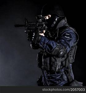 Special weapons and tactics (SWAT) team officer on black background
