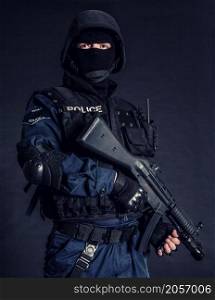 Special weapons and tactics SWAT team officer on black background