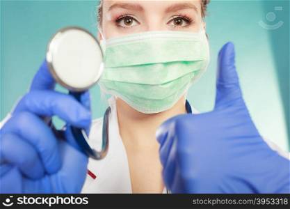 Specialist in mask with stethoscope.. Surgery and operation. Professional female doctor wearing special mask and holding stethoscope. Preparation for operation. Wide angle view