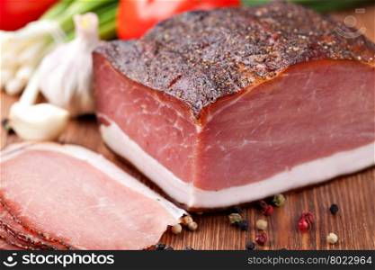 speck. Italian speck on a wooden table