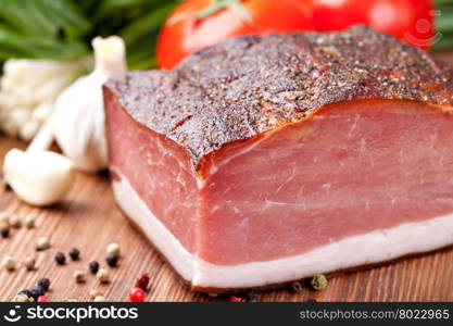 speck. Italian speck on a wooden table