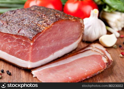 speck. Italian speck on a wooden table