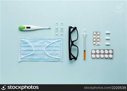 spectacles pills laptop near stethoscope blue surface