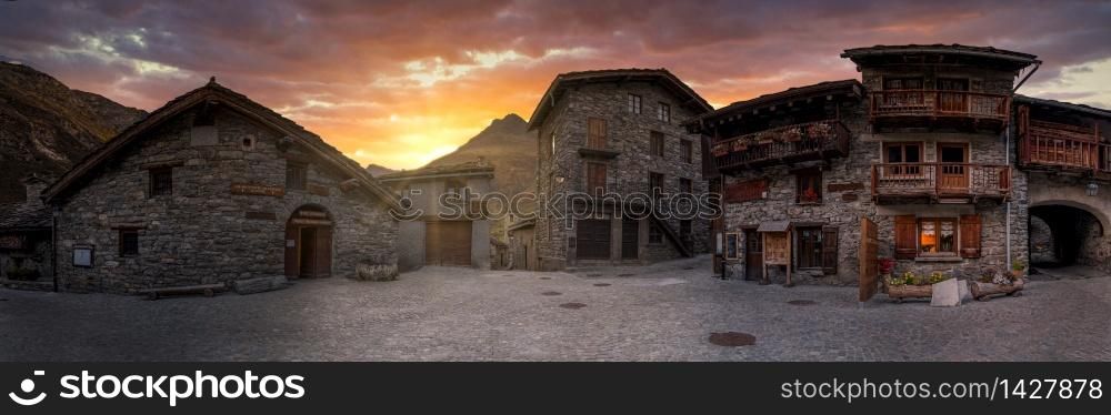 Spectacular sunset at small village with stone houses in the French Alps.