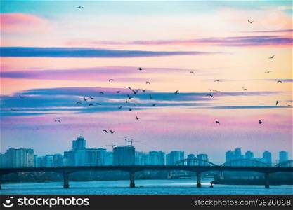 Spectacular sunset city view with bridge over Dnepr river. Kiev, Ukraine