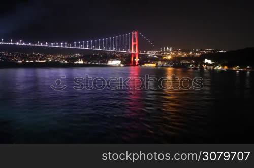 Spectacular view from a boat sailing away from Istanbul&acute;s bridge at night