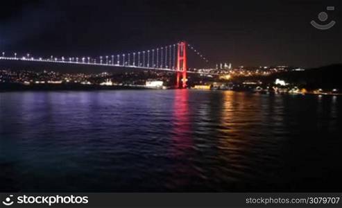 Spectacular view from a boat sailing away from Istanbul&acute;s bridge at night