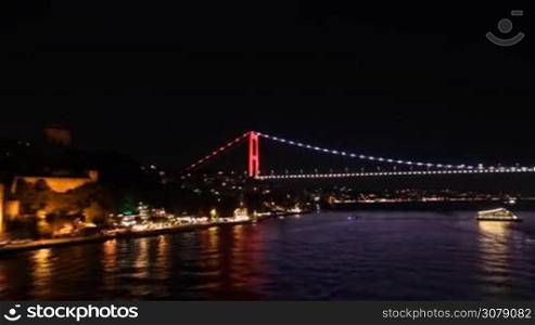 Spectacular view of bridge in Istanbul at night from a boat