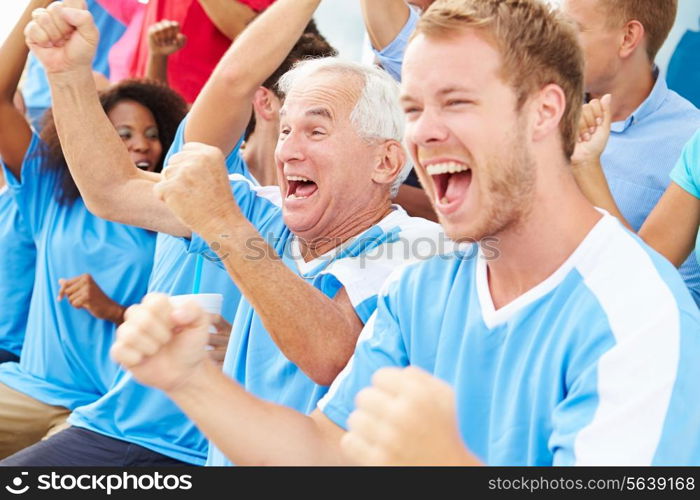 Spectators In Team Colors Watching Sports Event