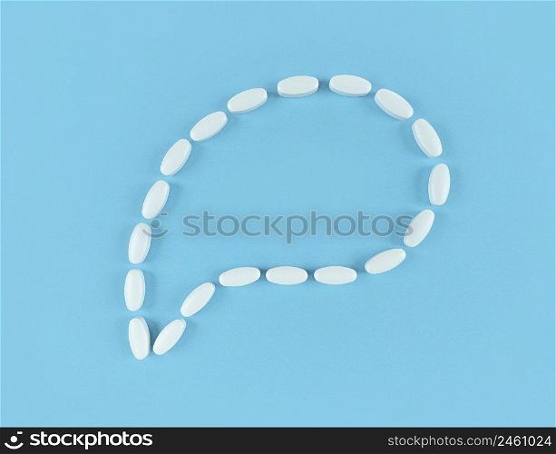 Speech bubble made from white tablets on a blue backdrop with copy space.. Speech bubble made from white tablets on blue backdrop with copy space.