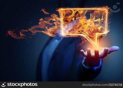 Speech fire icon. Fire glowing speech bubble icon on dark background
