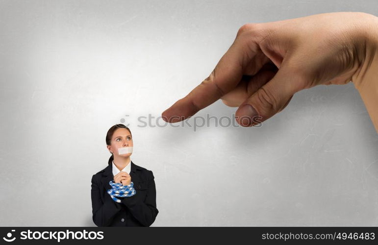 Speechless woman with tired hands. Young businesswoman with tape on mouth and tired hands