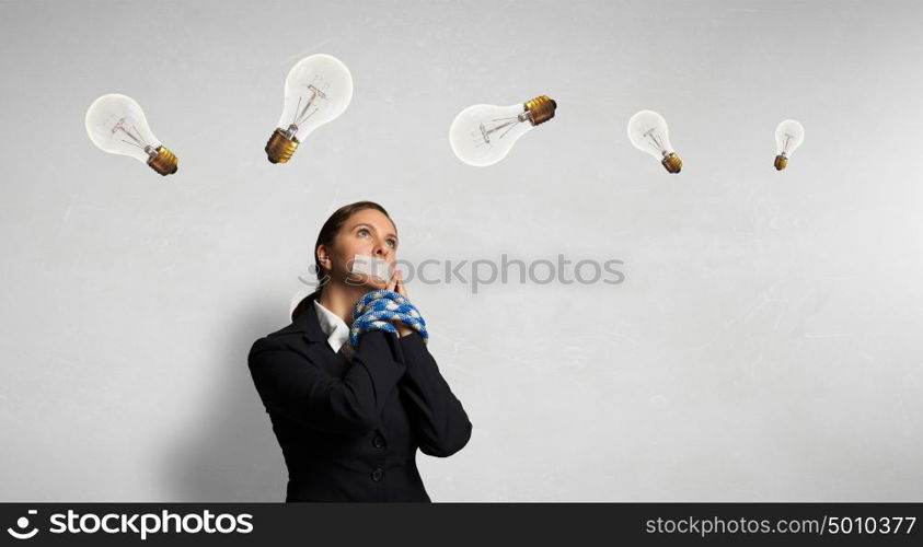 Speechless woman with tired hands. Young businesswoman with tape on mouth and tired hands