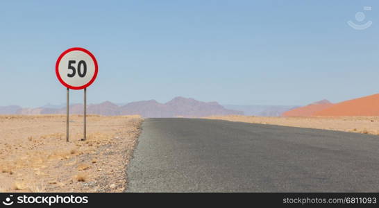 Speed limit sign at a desert road in Namibia, speed limit of 50 kph or mph