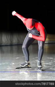 Speed skater at the starting line of a long distance race on an indoor ice rink