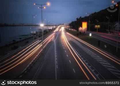 Speed Traffic - light trails on motorway highway at night, long exposure abstract urban background. Speed car traffic. Light trails on highway at night, long exposure abstract urban background