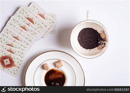 spelling cards and cup with  coffee grounds  around white