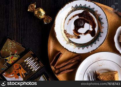 spelling coffee plate with coffee grounds and Tarot cards served at dark wooden table. devination concept . close up