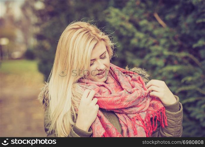 Spending free time on outdoor walking and relaxing outside concept. Woman dressed up warmly looking at surrounding nature.. Woman dressed warmly looking at bush