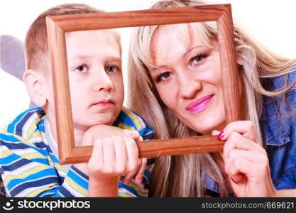 Spending time family bonds parenthood. Mother and son have fun play with empty picture frame hold in hand.. Mother and son play with empty frame.