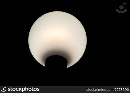 Spherical white lantern on the black background.