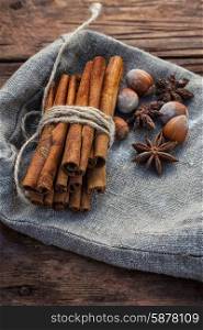 spice blend. Bunch of cinnamon sticks and star anise on sackcloth in vintage style