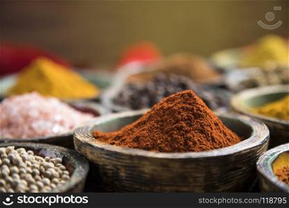 Spices and herbs and Wooden bowl. Spices and herbs in wooden bowls. Food and cuisine ingredients