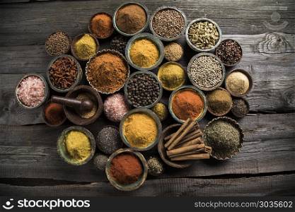 Spices and herbs and Wooden bowl. Spices and herbs in wooden bowls. Food and cuisine ingredients