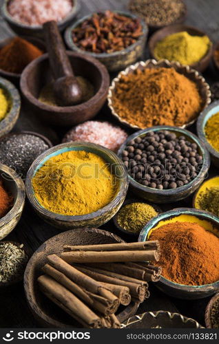 Spices and herbs and Wooden bowl. Spices over wooden background