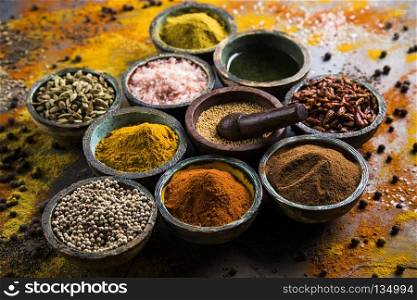 Spices and herbs and Wooden bowl. Spices over wooden background