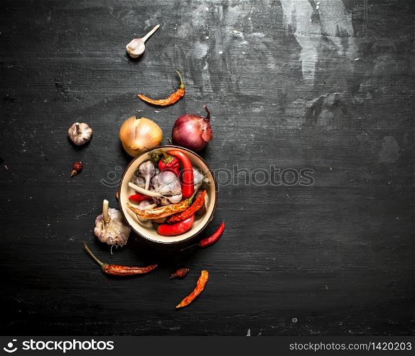 Spices and herbs. Fresh onion, garlic and chilli. On the black chalkboard.. Spices and herbs.