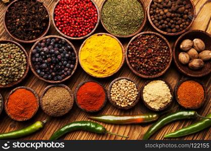 Spices and herbs in wooden bowls.. Spices and herbs in wooden bowls. Food and cuisine ingredients.