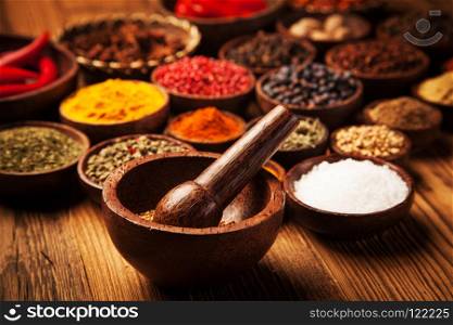 Spices and herbs in wooden bowls.. Spices and herbs in wooden bowls. Food and cuisine ingredients.