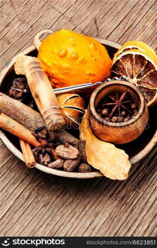 Spices and ingredients for mulled wine on rustic background. Seasonal warming drink mulled wine