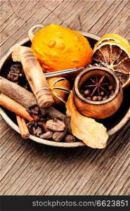 Spices and ingredients for mulled wine on rustic background. Seasonal warming drink mulled wine