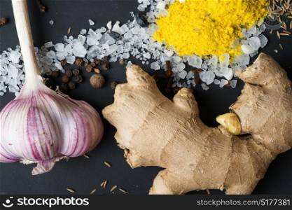 Spices and seeds with salt at black background. seasoning. Colorful natural additives.
